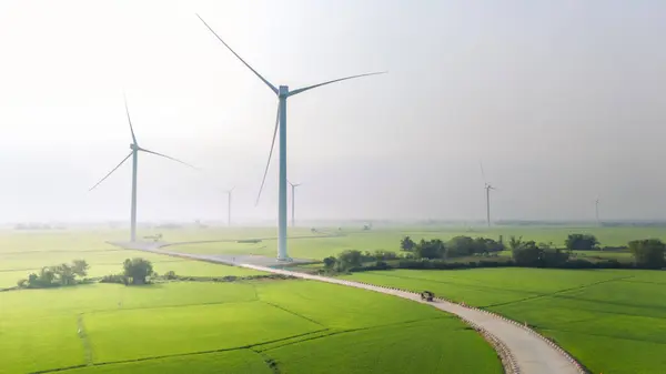 stock image view of turbine green energy electricity, windmill for electric power production, Wind turbines generating electricity on rice field at Phan Rang, Ninh Thuan province, Vietnam. Clean energy concept.