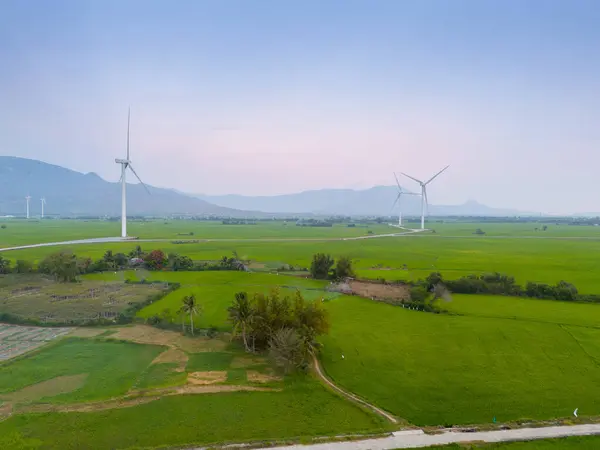 Stock image view of turbine green energy electricity, windmill for electric power production, Wind turbines generating electricity on rice field at Phan Rang, Ninh Thuan province, Vietnam. Clean energy concept.