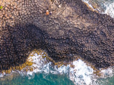 View of Ganh Da Dia or Da Dia Reef is a seashore area of uniformly interlocking basalt rock columns located along the coast in Tuy An town, Phu Yen Province, Vietnam. Travel and landscape concept clipart