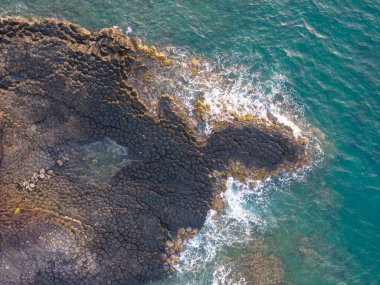 View of Ganh Da Dia or Da Dia Reef is a seashore area of uniformly interlocking basalt rock columns located along the coast in Tuy An town, Phu Yen Province, Vietnam. Travel and landscape concept clipart