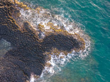 View of Ganh Da Dia or Da Dia Reef is a seashore area of uniformly interlocking basalt rock columns located along the coast in Tuy An town, Phu Yen Province, Vietnam. Travel and landscape concept clipart