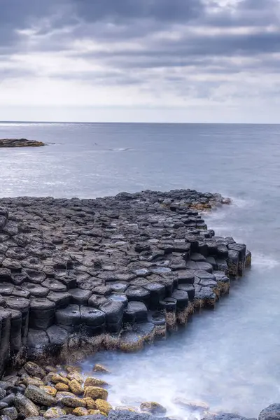 stock image View of Ganh Da Dia or Da Dia Reef is a seashore area of uniformly interlocking basalt rock columns located along the coast in Tuy An town, Phu Yen Province, Vietnam. Travel and landscape concept