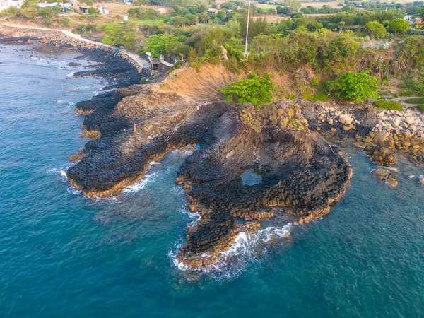 stock image View of Ganh Da Dia or Da Dia Reef is a seashore area of uniformly interlocking basalt rock columns located along the coast in Tuy An town, Phu Yen Province, Vietnam. Travel and landscape concept