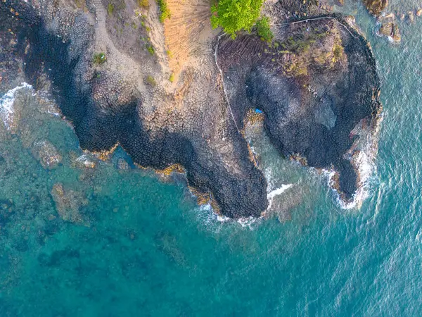 stock image View of Ganh Da Dia or Da Dia Reef is a seashore area of uniformly interlocking basalt rock columns located along the coast in Tuy An town, Phu Yen Province, Vietnam. Travel and landscape concept