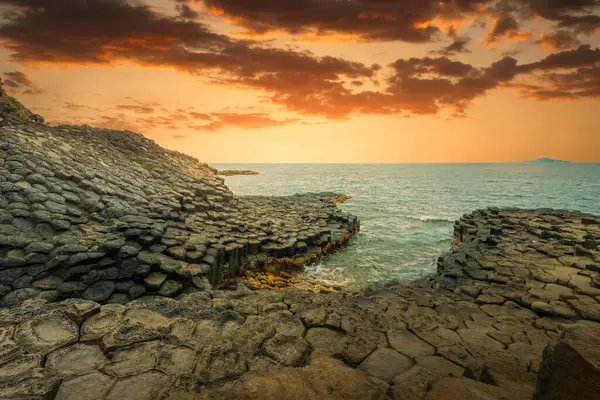 stock image View of Ganh Da Dia or Da Dia Reef is a seashore area of uniformly interlocking basalt rock columns located along the coast in Tuy An town, Phu Yen Province, Vietnam. Travel and landscape concept