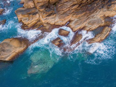 Kayalık ada kıyısına düşen güzel dalgaların, okyanus dalgalarının ve fantastik dalgaların hava aracı görüntüsü. Vietnam 'da okyanus. Seyahat ve deniz manzarası