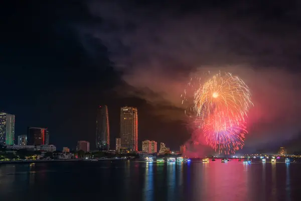 stock image Da Nang city, Vietnam - 13 Jul 2024: Skyline with fireworks light up sky over Han river in Da Nang City, Vietnam. Beautiful night view cityscape. Holidays, celebrating New Year and Tet holiday