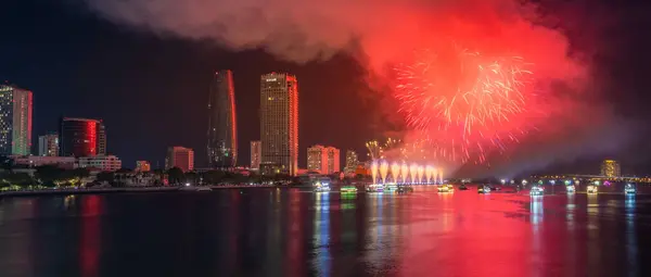 stock image Da Nang city, Vietnam - 13 Jul 2024: Skyline with fireworks light up sky over Han river in Da Nang City, Vietnam. Beautiful night view cityscape. Holidays, celebrating New Year and Tet holiday