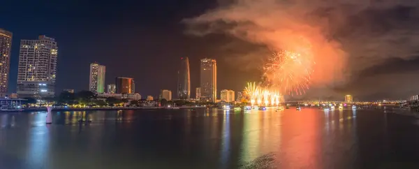 stock image Da Nang city, Vietnam - 13 Jul 2024: Skyline with fireworks light up sky over Han river in Da Nang City, Vietnam. Beautiful night view cityscape. Holidays, celebrating New Year and Tet holiday