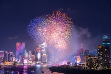 Kutlama. Vietnam 'ın Ho Chi Minh şehrinde (Saigon) havai fişeklerle gökyüzü aydınlandı. Güzel gece manzaralı şehir manzarası. Tatiller, yeni yılı ve Tet tatilini kutlamak.