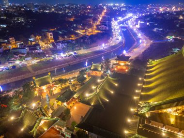 Aerial night view of Minh Thanh pagoda, a majestic Buddhist architectural structure in Pleiku city, Gia Lai province, Vietnam, text in photo mean Peace, Happy New Year. Travel concept. clipart