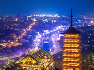 Gia Lai, Vietnam 'ın Pleiku şehrindeki görkemli bir Budist mimari yapı olan Minh Thanh Pagoda' nın hava gece görüşü barış ve mutlu yıllar anlamına geliyor. Seyahat kavramı.