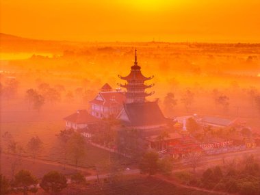 Aerial view of Buu Minh pagoda near Pleiku city, Gia Lai province, Vietnam. Morning views of pagoda and tea fields. Travel and landscape concept clipart