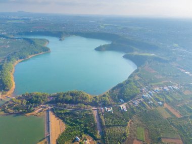 Aerial view of Bien Ho Che or Bien Ho tea fields, outside Pleiku city, Gia Lai province, Vietnam. Nature landscape, mountain and foggy far away. Travel and landscape concept. clipart