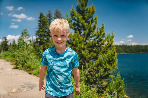 Boy smiling at Jenny Lake in Grand Teton National Park