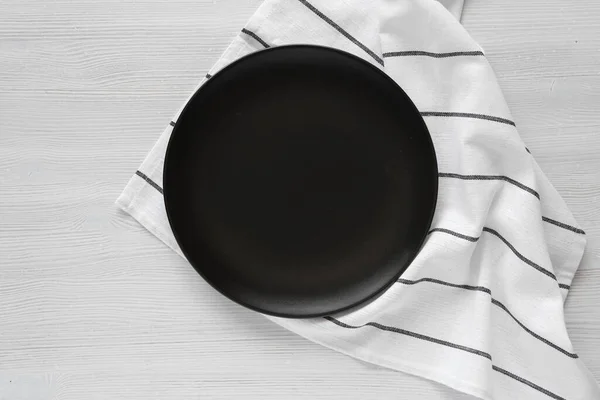Empty Black Plate White Striped Kitchen Towel Top View Minimalist Royaltyfria Stockbilder