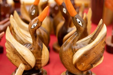 Selective focus on number of hand made wooden ducks for sale in market