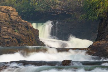 Long exposure photo of smooth waterfall flowing through steps