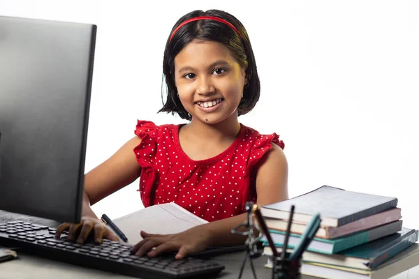 白い背景の研究テーブルでデスクトップコンピュータで勉強かなり美しいインドの女の子 — ストック写真