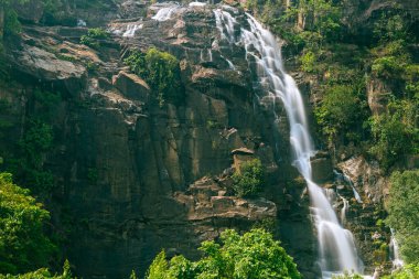 Silky milky smooth Sita waterfall flowing over green rocky hills at Ranchi Jharkhand India clipart