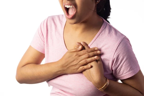 stock image An Indian woman holding her chest for pain showing painful expression on white background