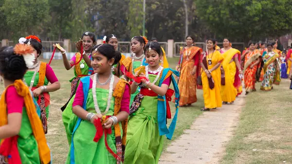 stock image Bolpur, Shantiniketan, West Bengal, India-25th March 2024: number of Indian Bengali girls celebrating holi performing traditional dance