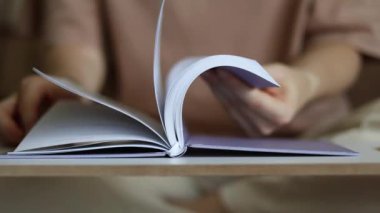 Kadın Elleri Bir Kitaptan Yapraklar. Geliştirme ve Eğitim Konsepti. Kitap severler günü. Bulanık Arkaplan ve Seçici Odaklanma.