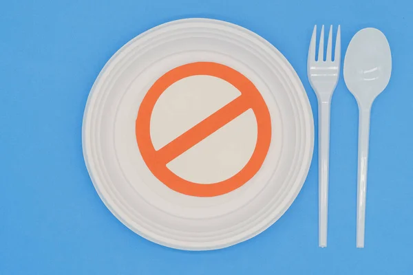 Prohibited symbol on plastic plates and cutlery. Ban on single-use plastics. Environmental concept. Do not damage the planet