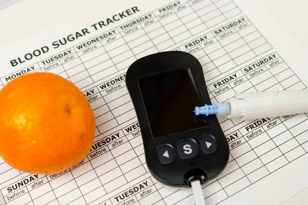 Medical equipment to measure blood glucose level with a lancing device with a pen. Testing blood sugar levels in diabetic patients. Oranges, food to reduce high blood sugar levels.