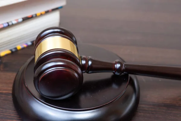 Judge\'s gavel on wooden table, background of legal books. Concept of legal legislation