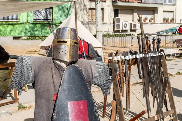 Full armour, helmet and traditional clothing to recreate the Middle Ages at an open-air festival