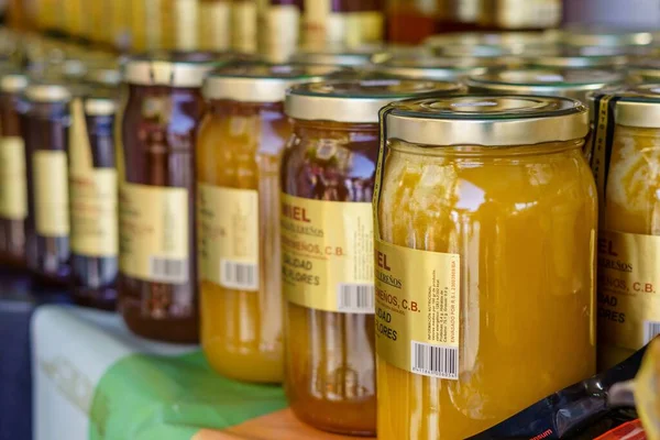 stock image Barcelona, Spain - May 15, 2022. Jars of homemade organic honey for sale at a street market stall.