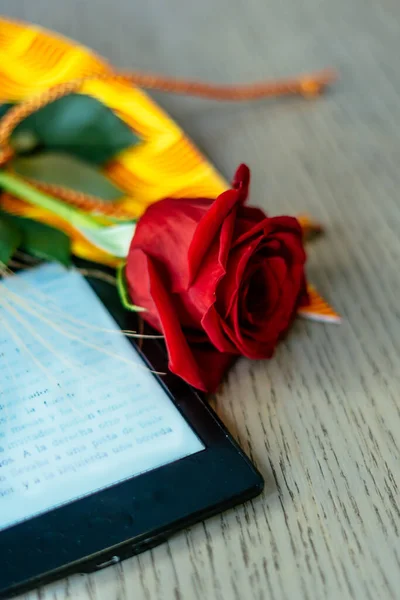 Stock image Red rose and electronic book to celebrate Sant Jordi day, April 23