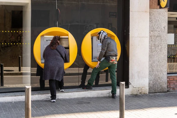 stock image Barcelona, Spain-May 2, 2023. Person operating an ATM on the street.