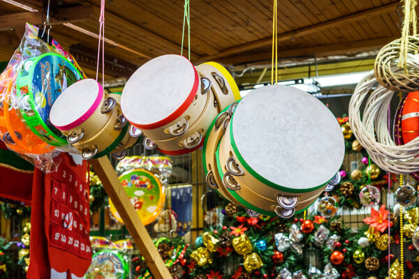 Tambourines for sale at a Christmas market in Spain Percussion musical instrument with rattles or bells that is played by striking it with the hand.