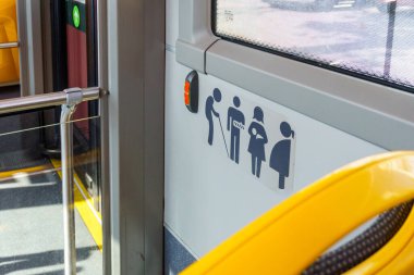 Promoting Inclusive Urban Mobility: A Detailed View of Priority Seating Icons in a City Bus Ensuring Accessibility and Courtesy for All clipart