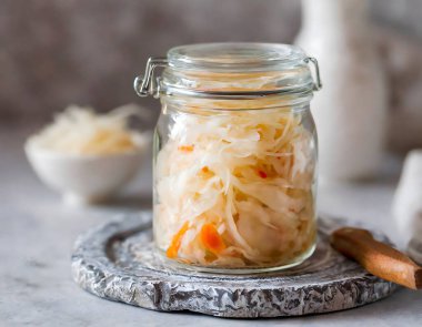 Homemade Sauerkraut in Glass Jar. Freshly prepared sauerkraut, rich in probiotics, ready for fermentation clipart