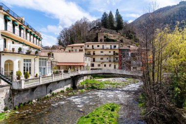 River Ter as it passes by the houses in the town of Camprodon in Girona, Spain. clipart