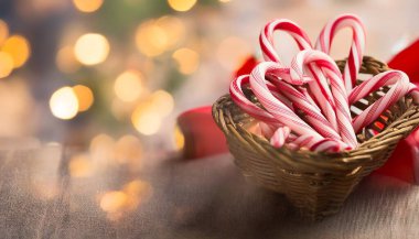 Festive Candy Canes Tied with a Bow on a Christmas Background clipart