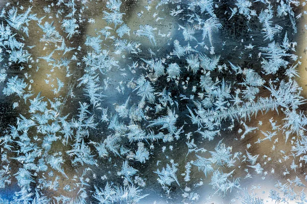 stock image A beautiful and varied pattern of frost on the window glass in winter