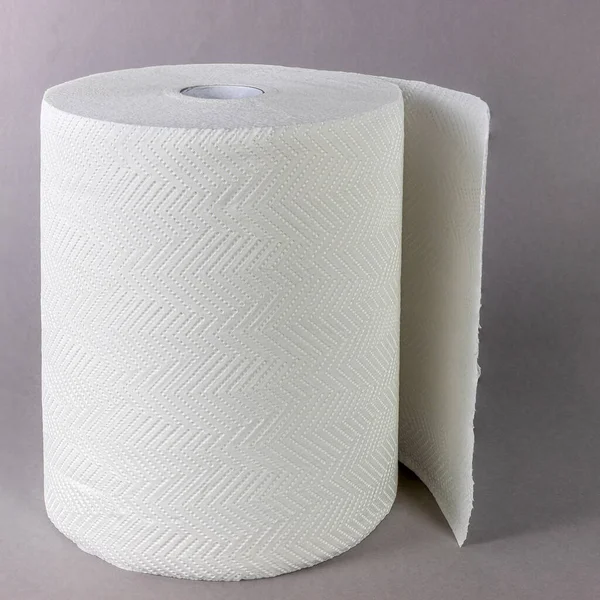 Paper towel roll on gray background close up side view