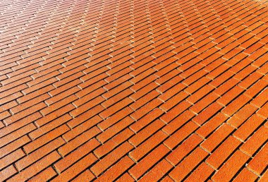 Orange rectanglesBackground of orange rectangular cobblestones in the city in the distance against the light