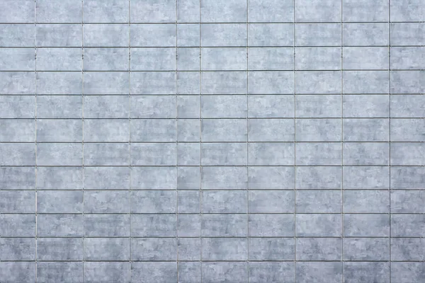 Close up of the building\'s renovated walls with modern textured tiles providing a stylish backdrop. Perfect for outdoor interior projects and architectural concepts.