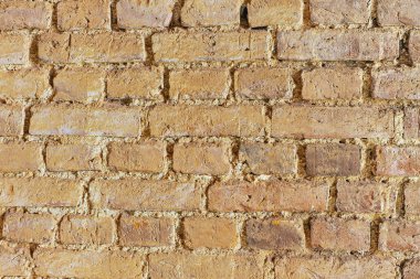 Eski, yıpranmış tuğla duvar dokusu arka planı. Zengin sıcak renklere ve karmaşık detaylara sahip bu resim, çeşitli yaratıcı projeler ve tasarımlar için mükemmeldir..