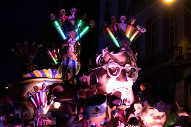 AALST, BELGIUM, 19 FEBRUARY 2023: Brightly illuminted floats with caricatures and dancers in Aalst carnival street parade. Aalst hosts one of the biggest Mardi Gras celebrations in Belgium.