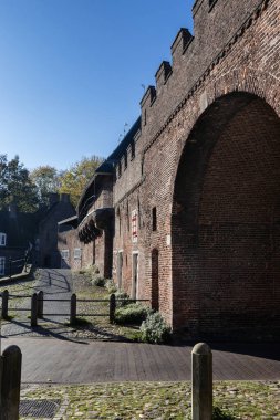 Rear view of the Koppelpoort medieval gate in the city of Amersfoort, in the Province of Utrecht, the Netherlands. Sunny day with blue sky. Copy space above left. clipart