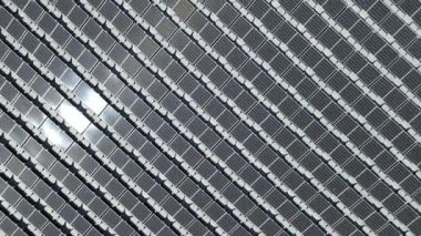 Aerial top view of solar panels or solar cells on buoy floating in lake sea or ocean. Power plant with water, renewable energy source.