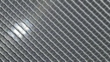 Aerial top view of solar panels or solar cells on buoy floating in lake sea or ocean. Power plant with water, renewable energy source.