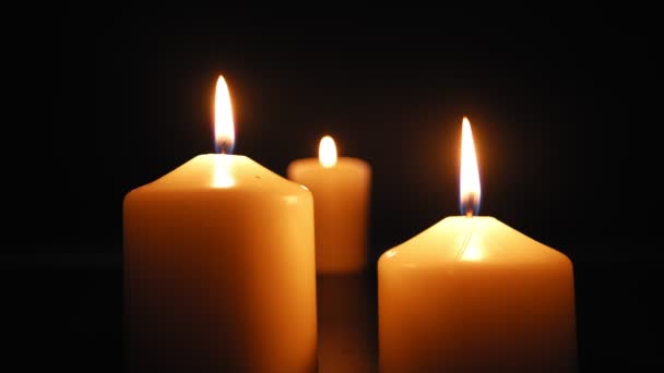 Three Candles Burn Soft Yellow Flame Dark Extinguished Wind Slow — Vídeos de Stock