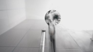 Flow of water from the shower. Bottom angle. Slow motion.